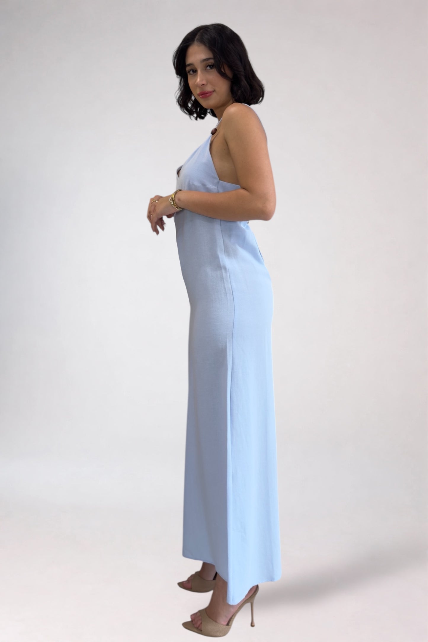 Woman wearing a light blue dress against a white background