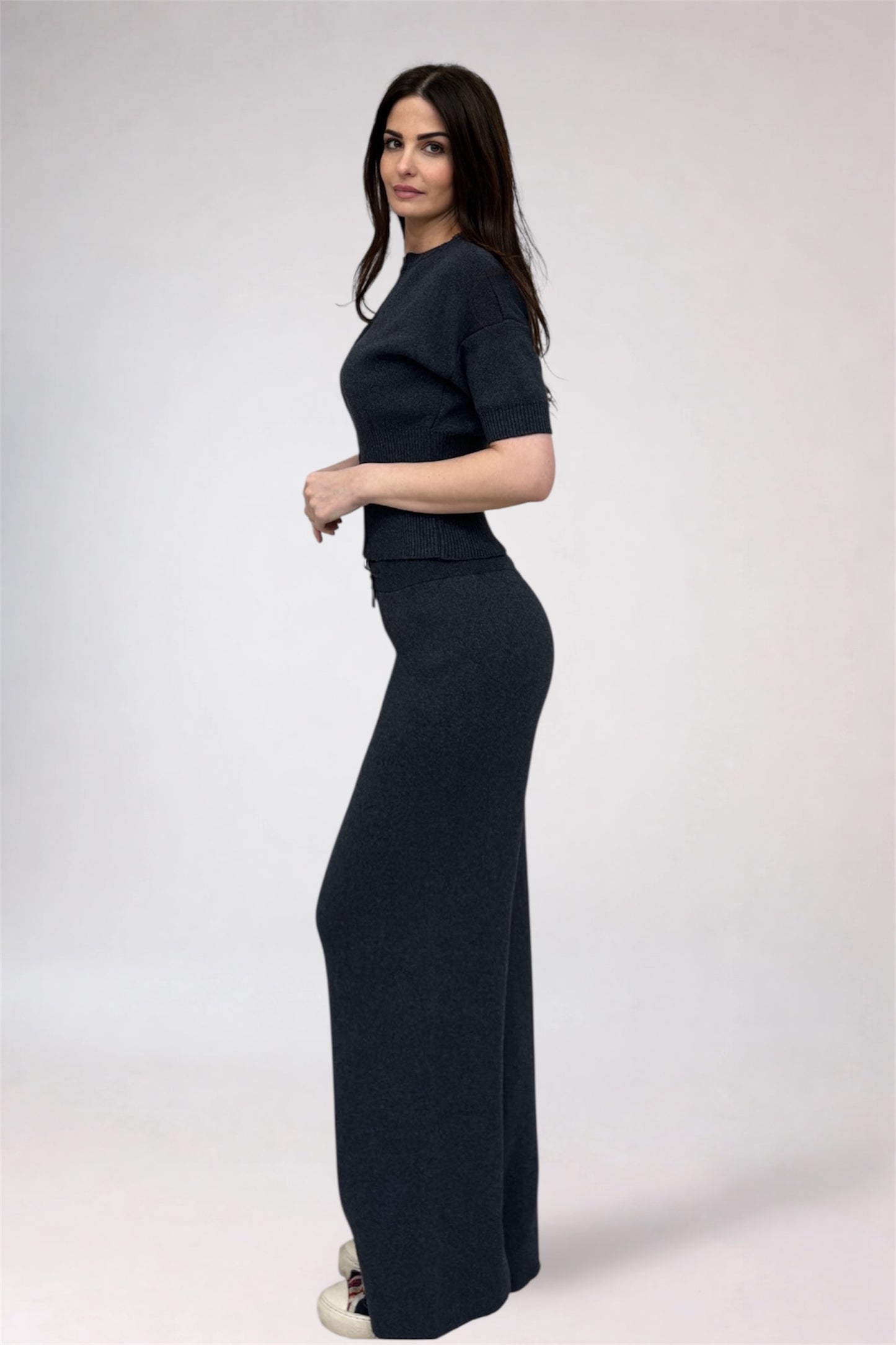 Woman wearing a dark blue outfit on a white background