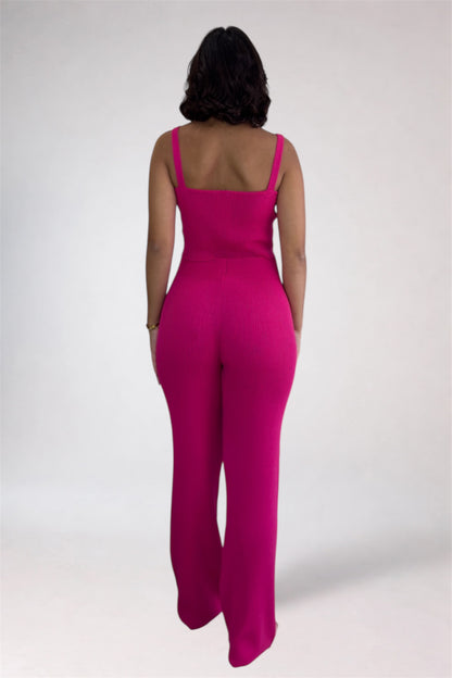 Person wearing a bright pink jumpsuit on a white background