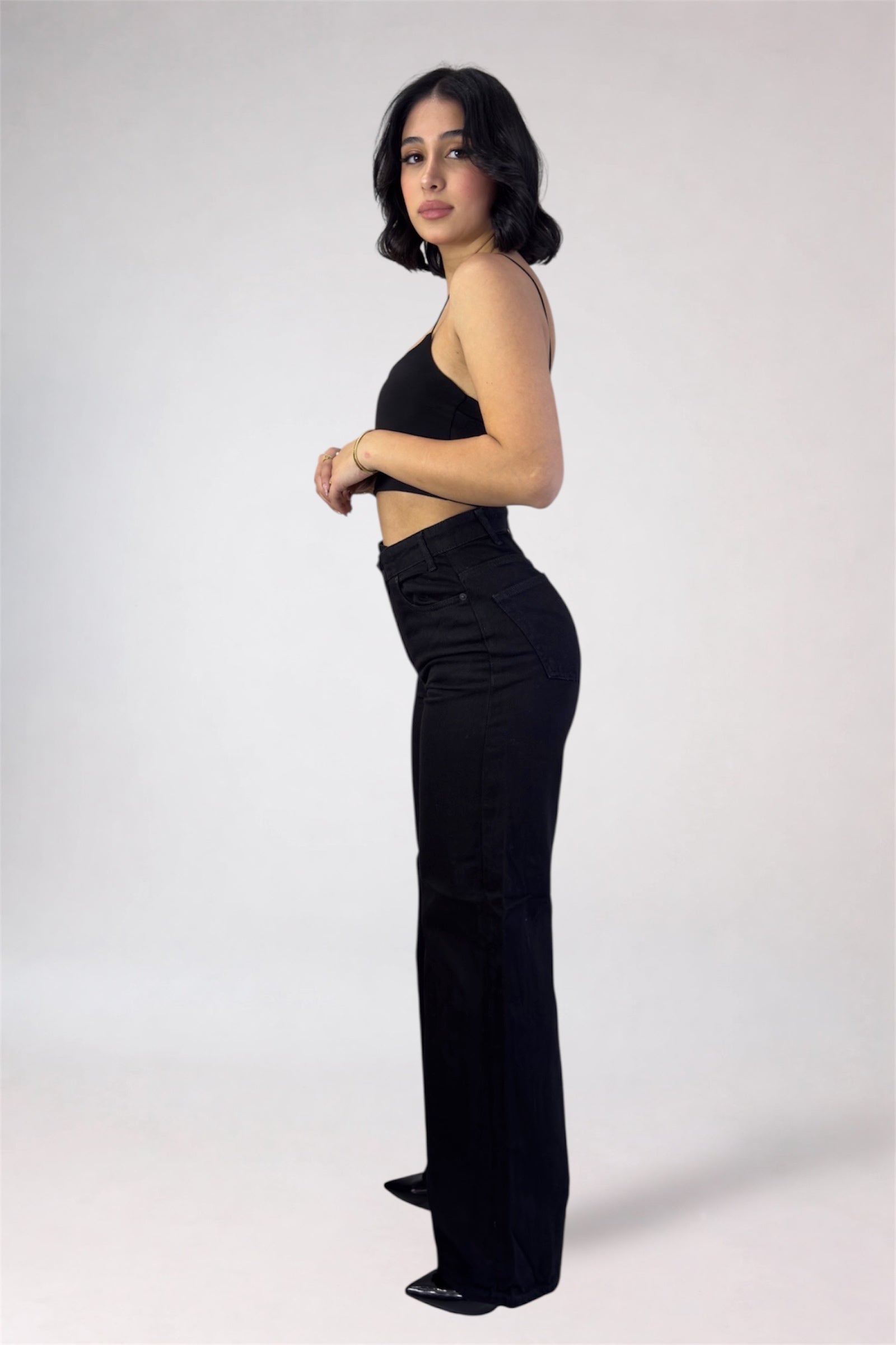 Woman wearing a black outfit on a white background
