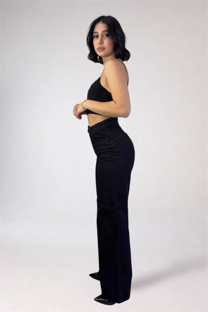 Woman wearing a black outfit on a white background