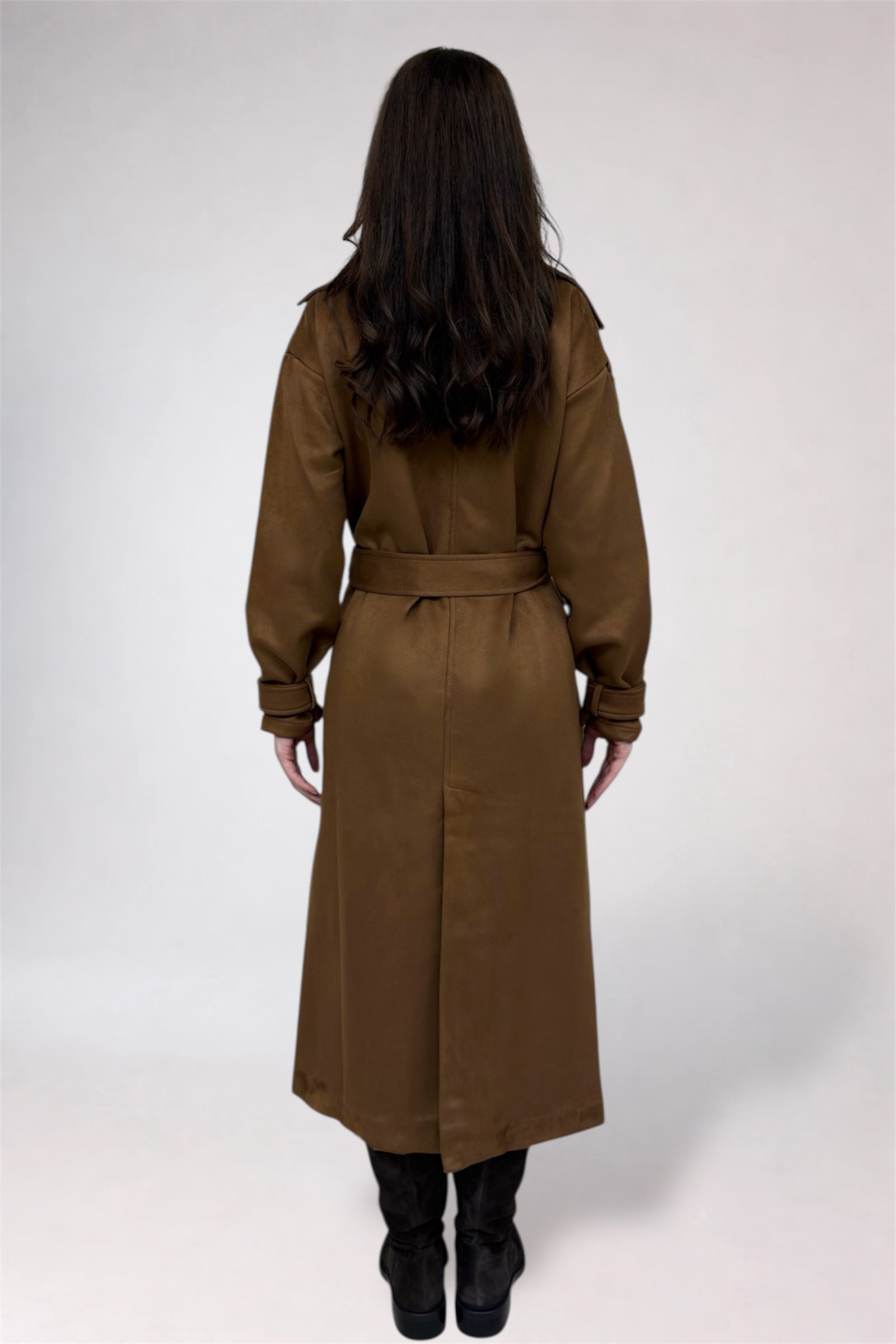 Woman wearing a brown trench coat on a white background
