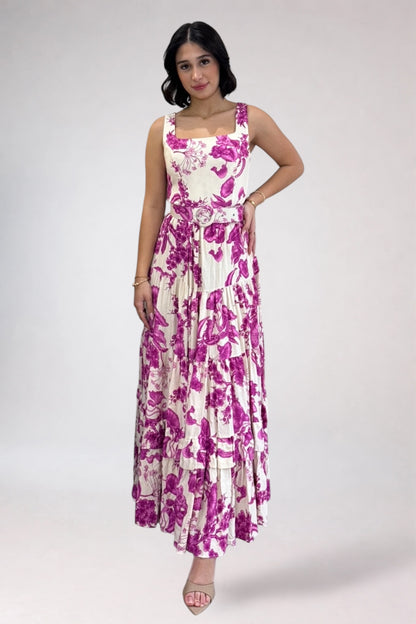 Woman wearing a floral dress with pink and purple flowers on a white background