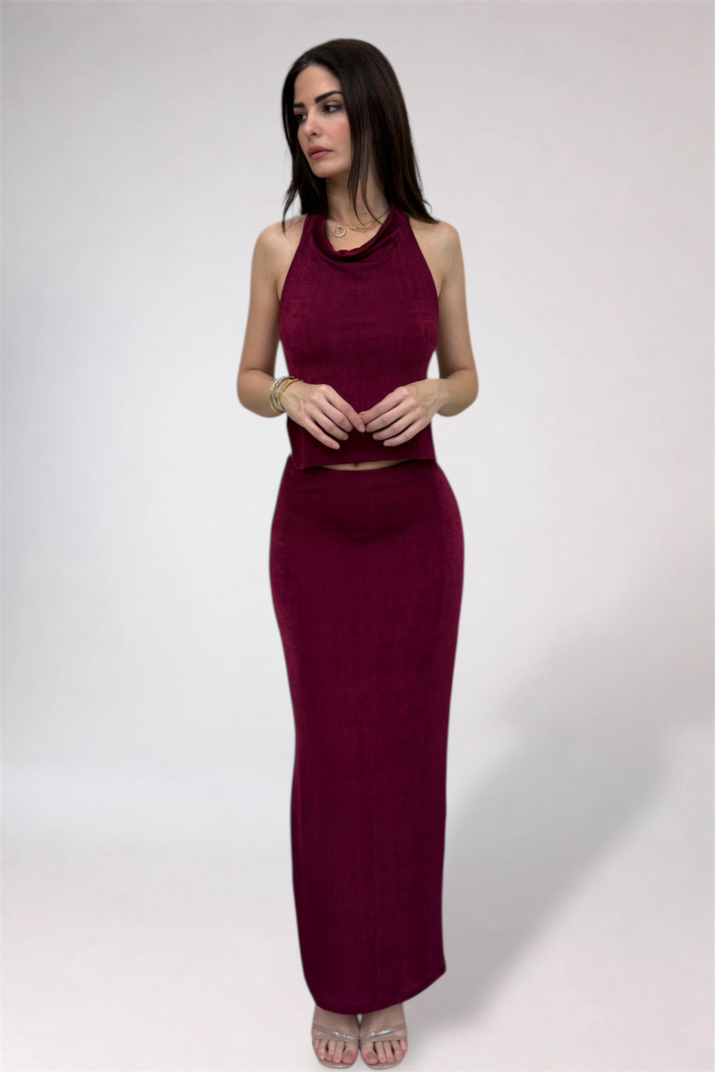 Woman wearing a burgundy dress against a white background