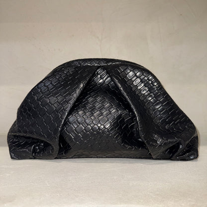 Black textured clutch bag on a light beige background