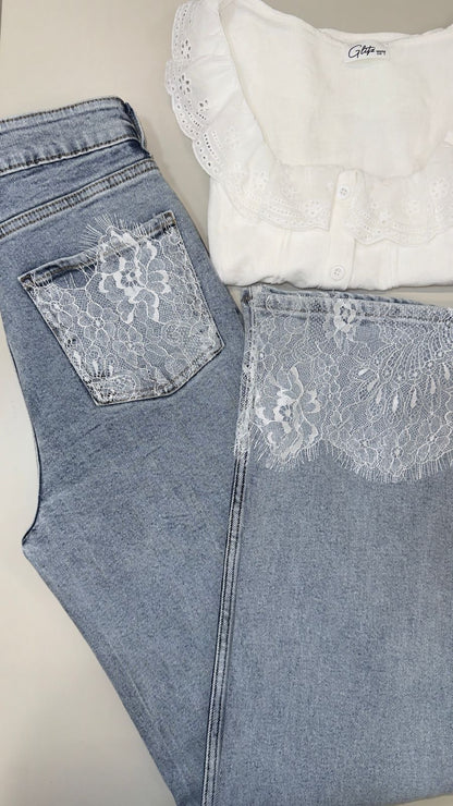 White lace top and blue jeans with lace detailing on a neutral background